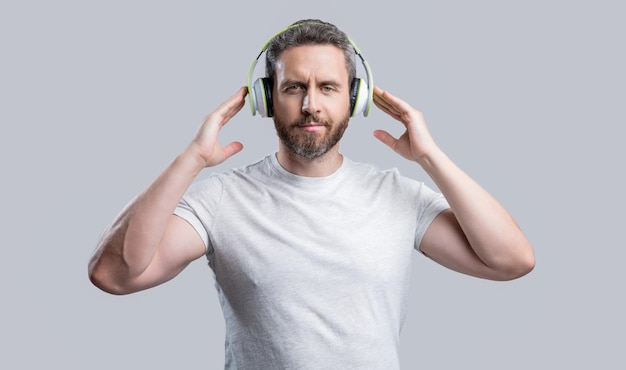 Photo of man listen music in headphones man listen music in headphones isolated on grey