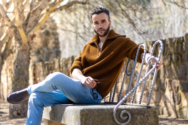 Photo of a man sitting on a wooden bench