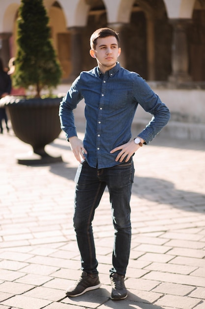 Photo of man standing in centre of the city Stulish man walking outside