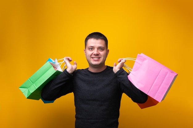 Photo of man with multicolored shopping bags