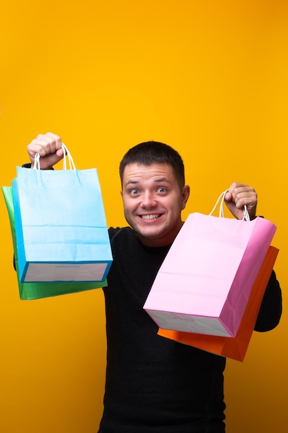 Photo of man with multicolored shopping bags