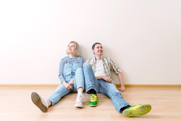 Photo of man and woman sitting on floor