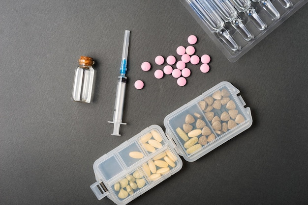 Photo of medical tablets vitamins and syringe