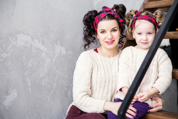 Photo of mother and daughter sitting together on the steps