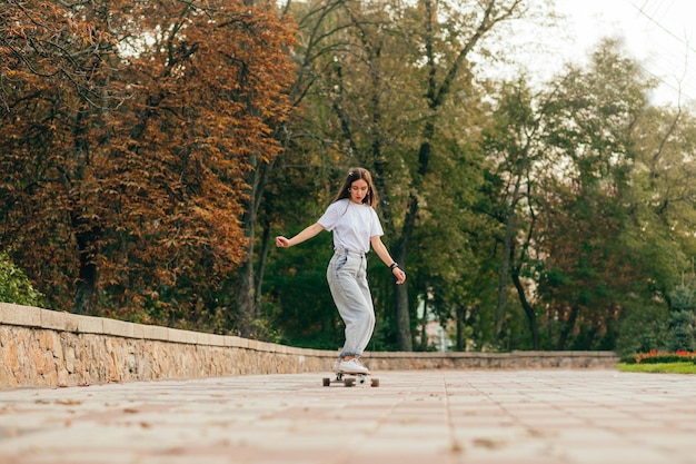 Photo in motion of a skateboard woman on a walk down the street on a sweat