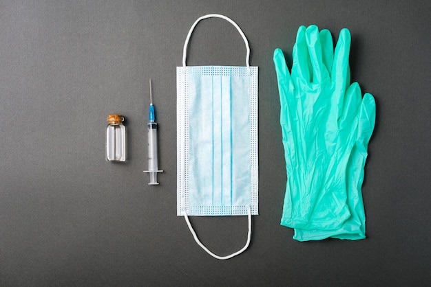 A photo of necessary tools for a vaccine on a dark table