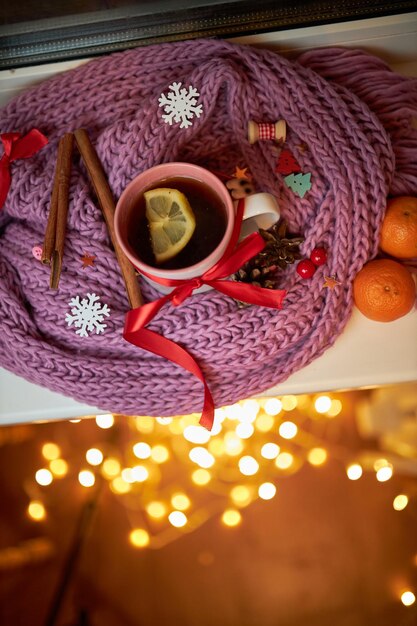 Photo photo for the new year card new year's composition view from above warm knitted scarf in purple