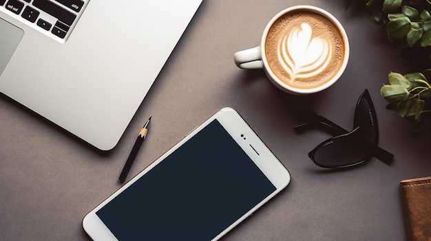 Photo of office table top view with laptop coffee cup and smartphone