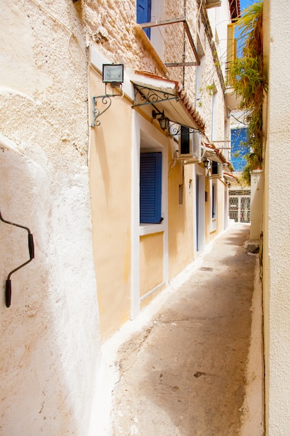 photo of one of cozy and little streets full plants in sunny and warm Greece