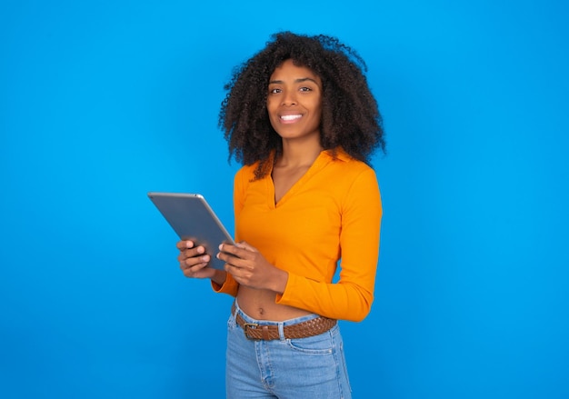 Photo of optimistic woman hold tablet