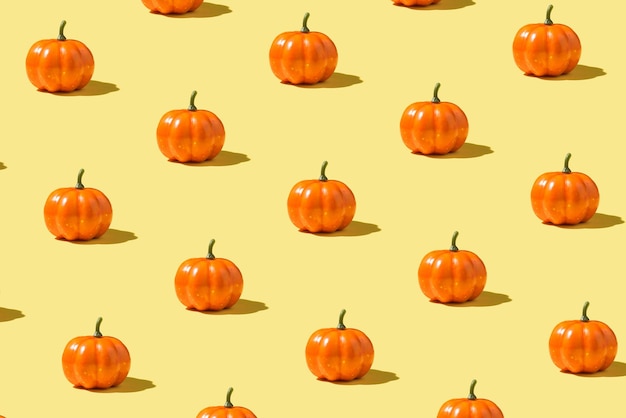 Photo of orange pumpkins on isolated yellow background