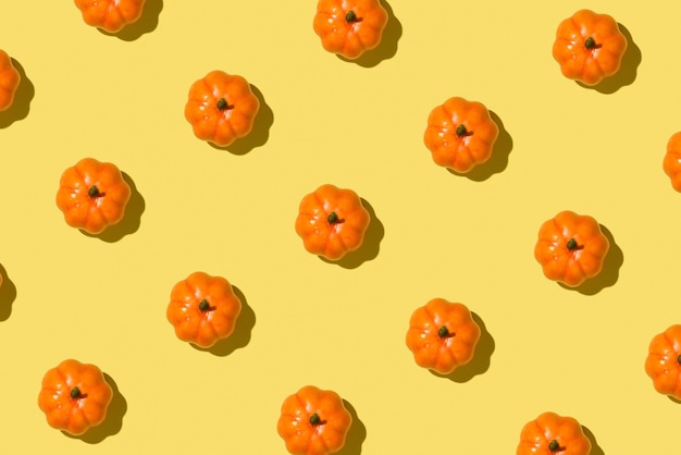 Photo of orange pumpkins on isolated yellow background