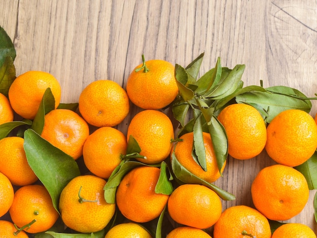 Photo of oranges fruit on the textured wooden table as the background