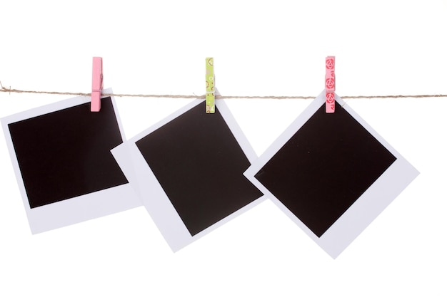 Photo photo paper hanging on the clothesline isolated on white