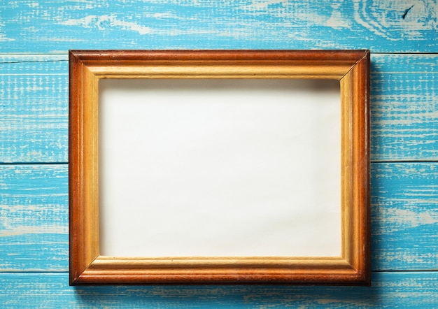 Photo picture frame on wooden background