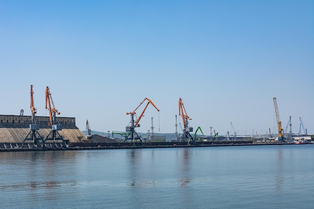 Photo of the pier and port cranes on a summer day