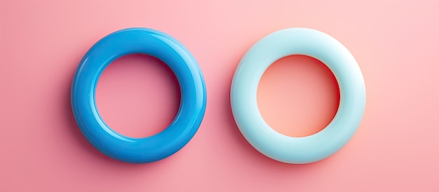 Photo photo of pink and blue rings on a vibrant pink background with plenty of copy space with copy space