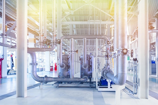 Photo of pipes and tanks. Chemistry and medicine production. Pharmaceutical factory. Yellow light tone