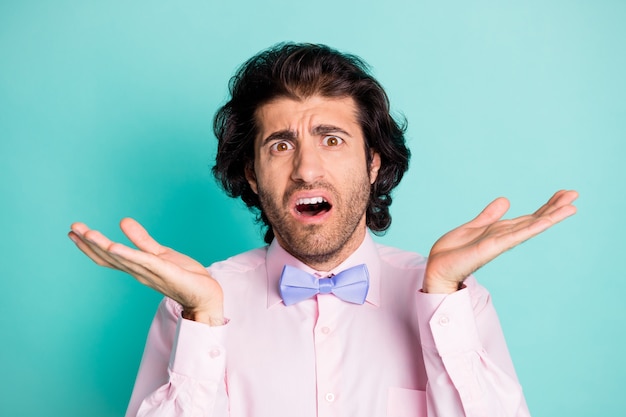 Photo portrait of disappointed guy isolated on pastel cyan colored background