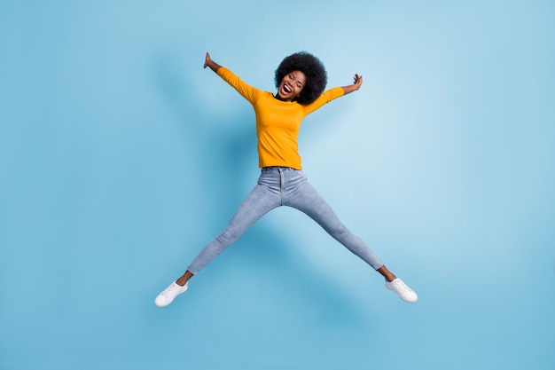 Photo portrait full body of woman jumping up spreading like star isolated on pastel blue colored background