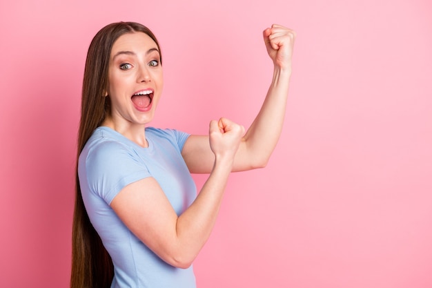 Photo portrait profile of screaming girl fighting showing two fists isolated on pastel pink colored background