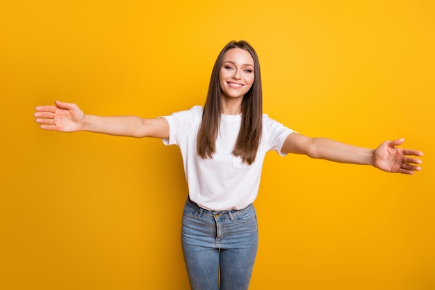 Photo portrait of woman hugging you camera isolated on bright yellow colored background