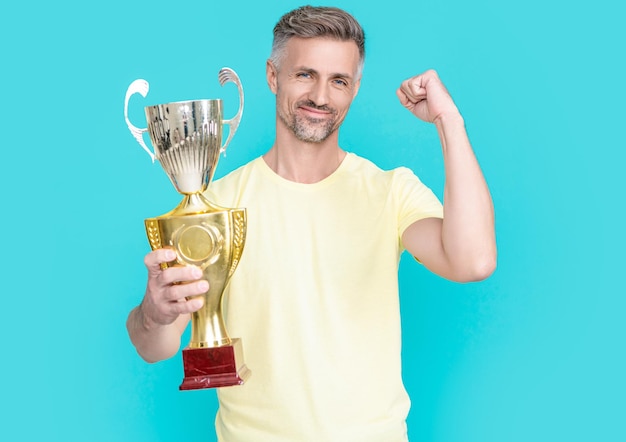 Photo of positive champion man celebrate victory with award champion man celebrate victory