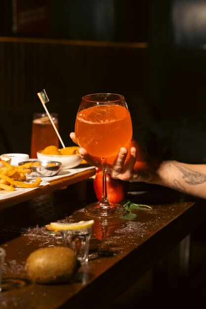 photo pouring orange wine into the glass