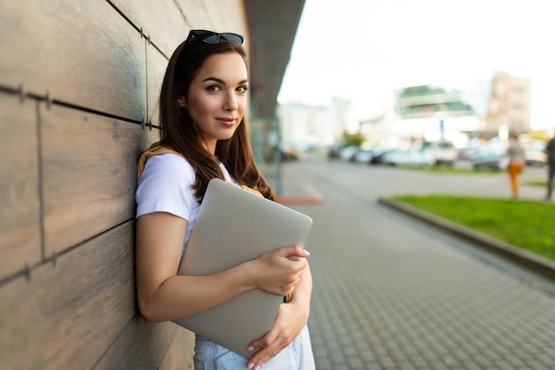 Photo of pretty attractive beautiful smiling positive charming young brunette young woman holding