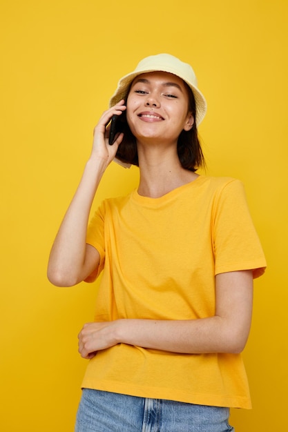 Photo pretty girl in a yellow hat Youth style casual talking on the phone Lifestyle unaltered