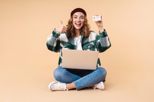 Photo of Pretty Happy Woman Holding Credit Card and Showing Thumb up