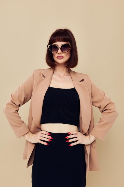 Photo pretty woman in a beige jacket elegant style sunglasses isolated background