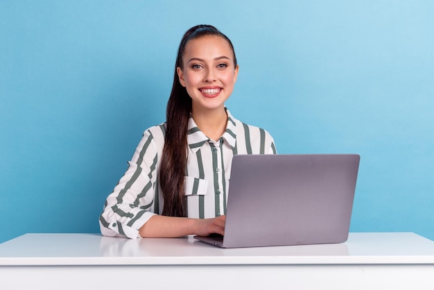 Photo of pretty young girl hold computer toothy smile isolated on blue color background