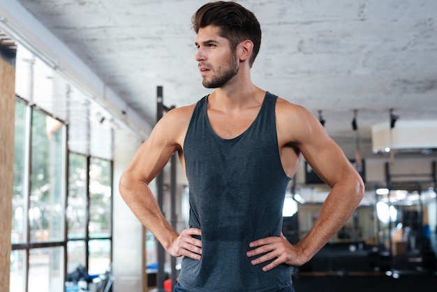 Photo in profile of fitness man in gym. looking away