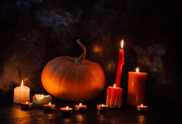 Photo of pumpkin with burning candles