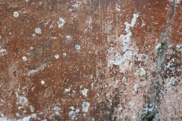 Photo of red wall texture with cement on the wall