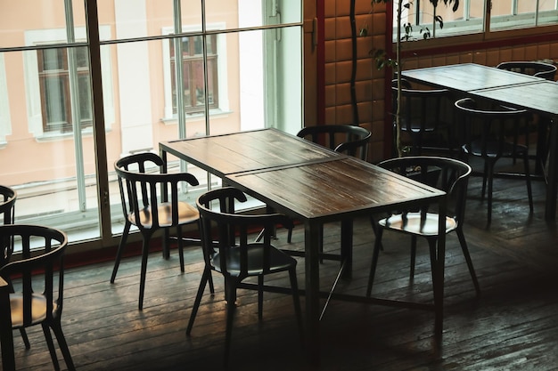 Photo of restaurant with empty wooden tables