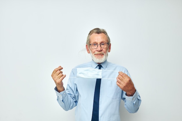 Photo of retired old man medical mask protection isolated background