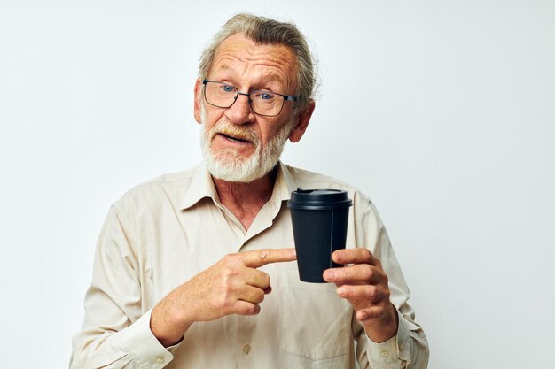 Photo of retired old man in a shirt and glasses a black glass isolated background