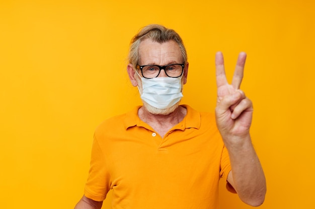Photo of retired old man with glasses face shield safety\
isolated background