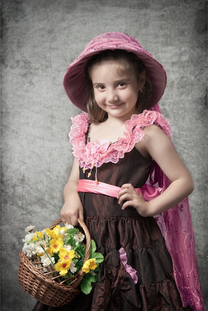 Photo in retro style of little girl with basket with flowers