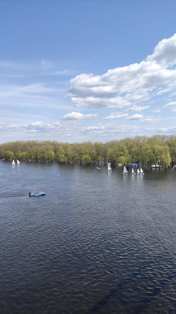 photo of a river with floating sailboats