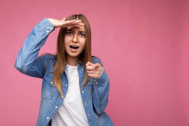 Photo of sad dissatisfied young attractive dark blonde woman with sincere emotions wearing stylish