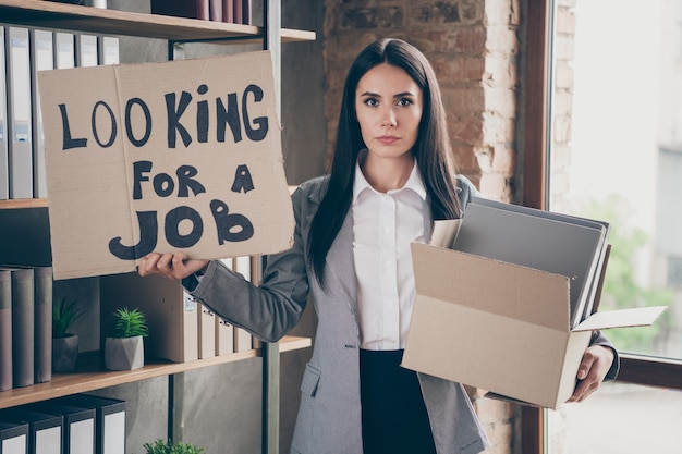 Foto foto di una seria economista ragazza preoccupata per la crisi aziendale in bancarotta il licenziamento del personale concetto dipendente cerca lavoro attesa casella di testo casella di testo indossare giacca giacca giacca nella postazione di lavoro