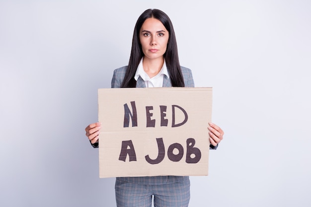 Photo of serious woman collar representative staff dismissal person lose job search showing paper card need work wear checkered plaid pants isolated over grey color background