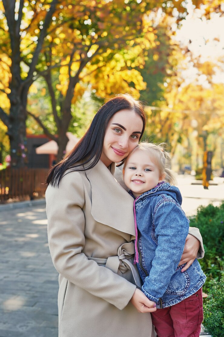 photo session of mother with daughter in autumn park