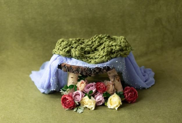 Photo shoot basket decorated with flowers. newborn photography basket on green background. backgroun