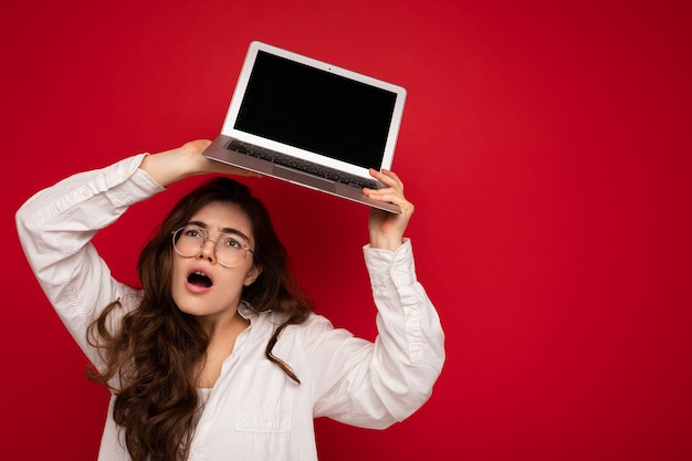 Photo shot of amazing funny happy beautiful smiling dark hair young woman holding computer laptop