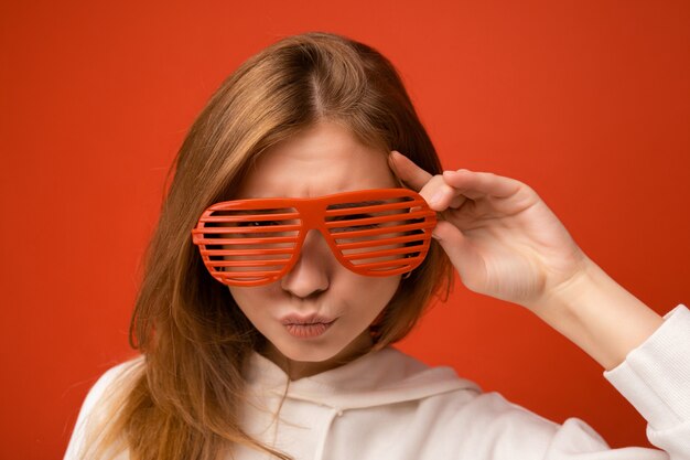 Photo shot of beautiful positive young blonde woman wearing casual clothes