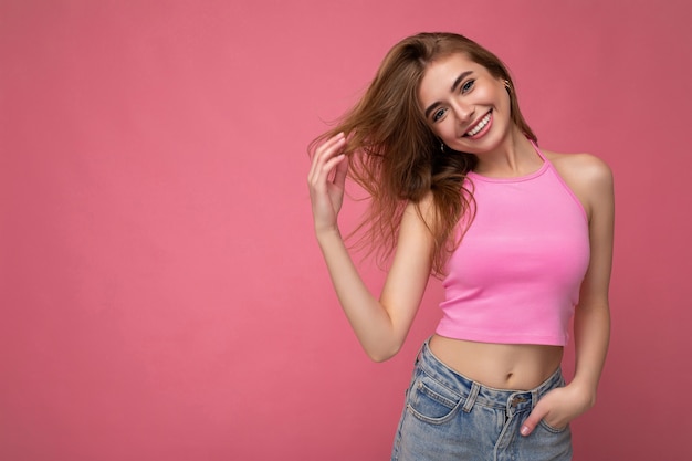 Photo shot of pretty joyful smiling young female person wearing casual trendy outfit